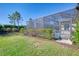 Screened pool area with lush landscaping and privacy fence at 26790 Weiskopf Dr, Englewood, FL 34223