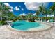 Relaxing resort-style pool with lounge chairs and palm trees at 26790 Weiskopf Dr, Englewood, FL 34223
