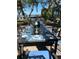 Elegant outdoor dining setting on a patio with water views at 3085 Bay Oaks Cir, Englewood, FL 34223