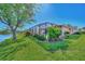 Landscaped backyard with screened lanai and water view at 3179 Osprey Ln, Port Charlotte, FL 33953