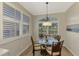 Charming breakfast nook with glass-top table and four chairs at 3179 Osprey Ln, Port Charlotte, FL 33953