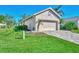 Tan house with a two-car garage and nicely manicured lawn at 3179 Osprey Ln, Port Charlotte, FL 33953
