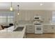 Updated kitchen with white appliances and gray cabinets at 3179 Osprey Ln, Port Charlotte, FL 33953