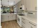 Updated kitchen with light grey cabinets, quartz countertops, and gas range at 3179 Osprey Ln, Port Charlotte, FL 33953