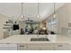 Kitchen island with sink, quartz countertops, and view into living room at 3179 Osprey Ln, Port Charlotte, FL 33953