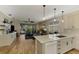 Open kitchen with island, white cabinets, and access to living room at 3179 Osprey Ln, Port Charlotte, FL 33953
