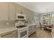 Modern kitchen with white appliances and breakfast area at 3179 Osprey Ln, Port Charlotte, FL 33953