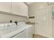 Convenient laundry room with washer, dryer, and storage at 3179 Osprey Ln, Port Charlotte, FL 33953