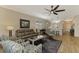 Open living room with gray couches and access to kitchen at 3179 Osprey Ln, Port Charlotte, FL 33953