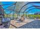 Relaxing screened lanai with paver patio, hot tub, and outdoor kitchen at 3179 Osprey Ln, Port Charlotte, FL 33953