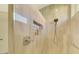 Walk-in shower with neutral tile and built-in shower caddy at 3179 Osprey Ln, Port Charlotte, FL 33953