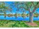 Serene waterfront view, showcasing mature trees and homes at 3179 Osprey Ln, Port Charlotte, FL 33953