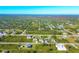 Aerial view of a residential area with many houses and green spaces at 4375 Kempson Ln, Port Charlotte, FL 33981