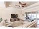 Spacious living area with light leather furniture and access to a patio at 4442 Windsong Ave, North Port, FL 34287