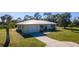 Single-story home with metal roof and garage at 445 Stewart St, Englewood, FL 34223