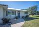 Front view of charming ranch house with walkway and mature landscaping at 445 Stewart St, Englewood, FL 34223