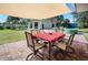 Outdoor patio area with seating and a shade canopy at 445 Stewart St, Englewood, FL 34223