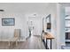 Bright and airy entryway with wood-look flooring and console table at 611 Chestnut Ln, Englewood, FL 34223