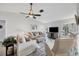 Living room with hardwood floors, comfy seating and a large TV at 611 Chestnut Ln, Englewood, FL 34223