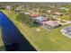 Aerial view of canal-front property with lush landscaping at 634 Boundary Blvd, Rotonda West, FL 33947