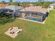 Home with a pool, screened enclosure, and fire pit at 634 Boundary Blvd, Rotonda West, FL 33947