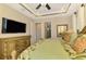 King-size bedroom with a large TV, dresser, and ensuite bathroom at 634 Boundary Blvd, Rotonda West, FL 33947