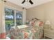 Bedroom with queen bed, coastal decor, and sliding glass doors to the patio at 634 Boundary Blvd, Rotonda West, FL 33947