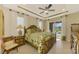 King-size bedroom with pool view and ensuite bathroom at 634 Boundary Blvd, Rotonda West, FL 33947