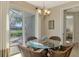 Bright breakfast nook with glass-top table and view of backyard at 634 Boundary Blvd, Rotonda West, FL 33947