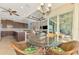 Breakfast nook with glass-top table and wicker chairs, overlooking the pool at 634 Boundary Blvd, Rotonda West, FL 33947