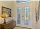 Elegant entryway featuring beautiful double doors and unique art at 634 Boundary Blvd, Rotonda West, FL 33947