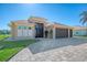 House with a three-car garage, paver driveway, and landscaping at 634 Boundary Blvd, Rotonda West, FL 33947