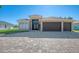 Two-story house with a three-car garage and a paver driveway at 634 Boundary Blvd, Rotonda West, FL 33947