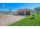 House with a three-car garage and paver driveway at 634 Boundary Blvd, Rotonda West, FL 33947