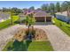 Attractive home with paver driveway, fountain, and lush landscaping at 634 Boundary Blvd, Rotonda West, FL 33947