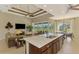 Spacious kitchen with island, stainless steel appliances, and dark wood cabinets at 634 Boundary Blvd, Rotonda West, FL 33947