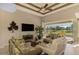 Bright living room with pool view, comfy seating, and large TV at 634 Boundary Blvd, Rotonda West, FL 33947