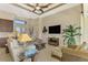 Relaxing living room featuring wicker furniture and large TV at 634 Boundary Blvd, Rotonda West, FL 33947