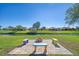Relaxing patio area with fire pit and colorful benches at 634 Boundary Blvd, Rotonda West, FL 33947