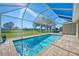 Relaxing pool with screened enclosure and water view at 634 Boundary Blvd, Rotonda West, FL 33947