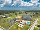 Aerial view showing community pool, tennis courts, and clubhouse at 6379 Coliseum Blvd, Port Charlotte, FL 33981