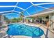 Refreshing swimming pool under a screened patio enclosure at 7027 Mineola Rd, Englewood, FL 34224