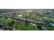 Aerial view of community with golf course, homes, and waterways at 76 Long Meadow Ct, Rotonda West, FL 33947