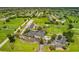 Beautiful aerial of community clubhouse surrounded by golf course, parking and lush landscaping at 76 Long Meadow Ct, Rotonda West, FL 33947