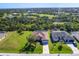 Aerial view of a home with a well-manicured lawn in a quiet neighborhood at 76 Long Meadow Ct, Rotonda West, FL 33947