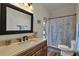 Bathroom featuring tile floors, a large mirror, and a shower/tub combo at 76 Long Meadow Ct, Rotonda West, FL 33947