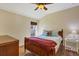 Comfortable bedroom featuring wood floors and a large window at 76 Long Meadow Ct, Rotonda West, FL 33947
