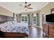 Bedroom with wood floors, ceiling fan and bay window bringing in natural light at 76 Long Meadow Ct, Rotonda West, FL 33947