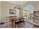 Cozy dining room with natural light, a painting, and a wooden dining set, creates a warm, inviting atmosphere at 76 Long Meadow Ct, Rotonda West, FL 33947