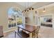 Charming dining room featuring a large window, bench seating, and modern light fixture, perfect for gatherings at 76 Long Meadow Ct, Rotonda West, FL 33947